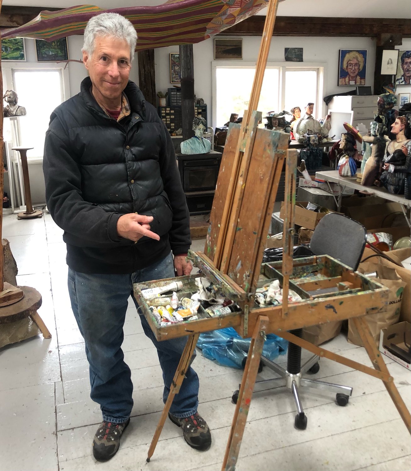 Visual artist Allan Rubin instructing Fox on the complicated fine art of opening and closing the real-dear artsy-fartsy plein air easel that will showcase one of Fox's pieces in the exhibit.